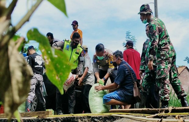 Foto: Kasat Lantas Polres Lumajang (memegang karung - bermasker hijau)
