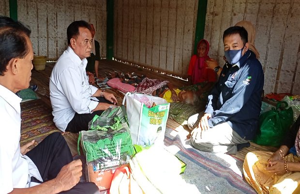 Foto : Kepala Dinas Sosial Kabupaten Pamekasan, M. Tarsun bantu langsung dua lansia yang hidup memprihatinkan.