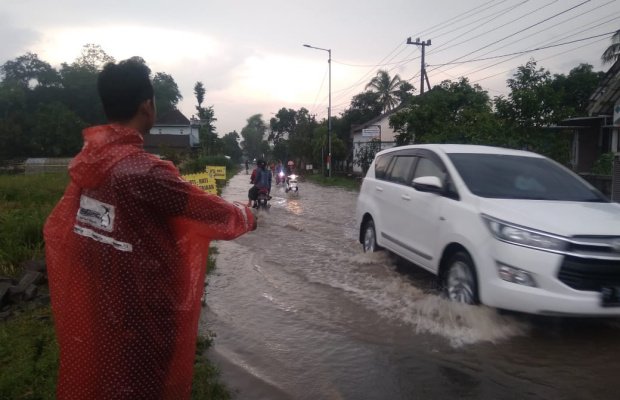 Foto: Air meluap ke jalan raya.