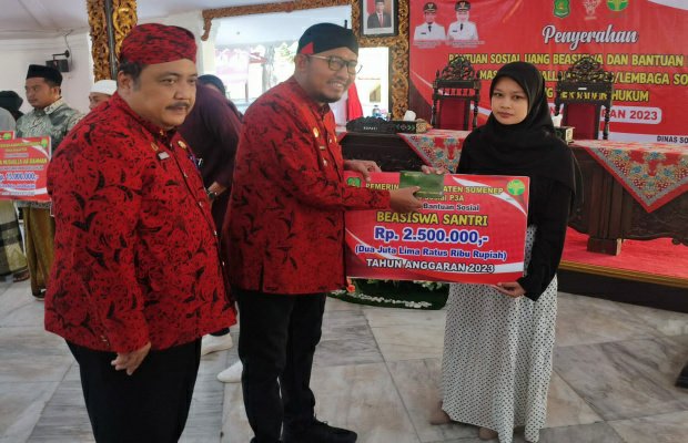 Foto: (Paling kiri) Kadinsos P3A Sumenep Achmad Dzulkarnain, saat mendampi Bupati Fauzi  memberikan beasiswa secara simbolis