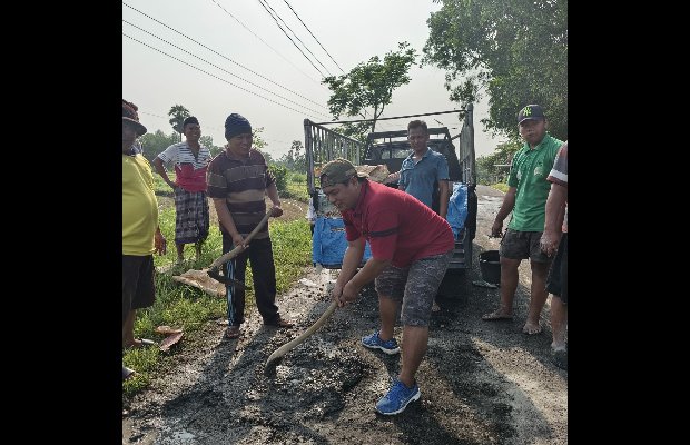 Foto:Komunitas Keles Kellas Peduli jalan berlubang sedang melakukan tambal sulam jalan.