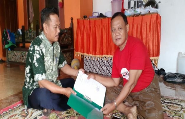 Foto: Salah Satu Petugas Kecamatan Pademawu Saat Mengantarkan Berkas Kerumahnya Agus