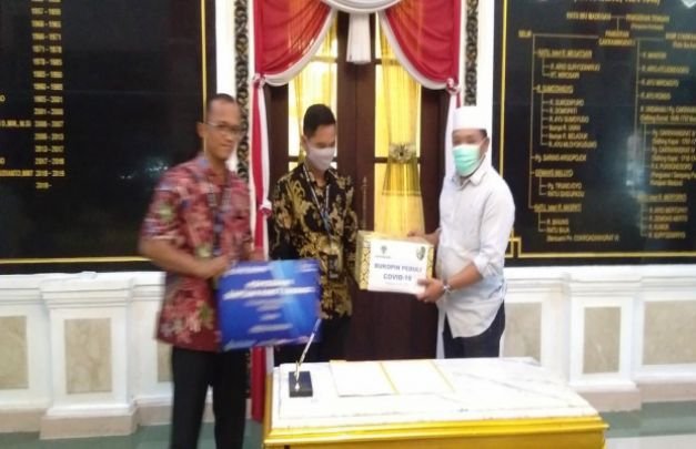 Foto :Resa, Kepala Bank Bukopin cabang Sampang menyerahkan Bantuan sembako ke Bupati Sampang H. Slamet Junaidi