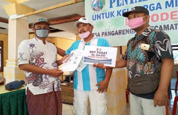 Foto : H. Kusairi tengah mengalihkan bantuan kepada masyarakat yang kurang mampu