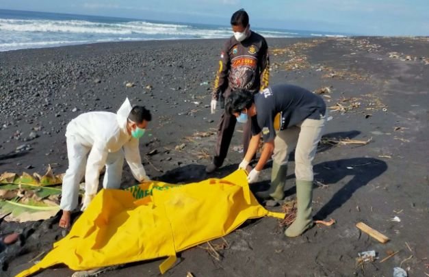 Foto: Petugas kepolisian dan tim medis mengevakuasi mayat