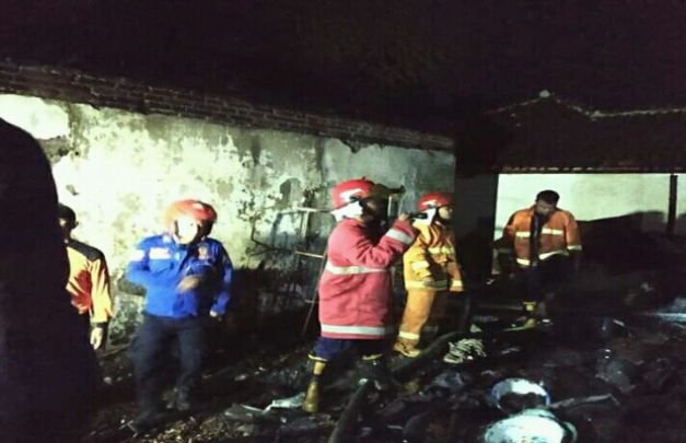 FOTO: petugas saat memadamkan api yang melalapi Dua Rumah warga