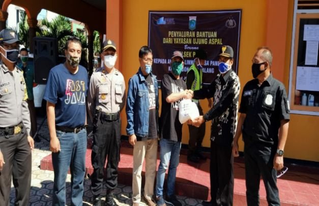 Foto:Ketua YUA Jatim, Alex Yudawan secara simbolis menyerahkan paket sembako kepada Kepala Desa Pandesari untuk dibagikan kepada warga terdampak Covid-19.