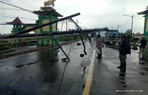 Foto: Sejumlah tiang listrik roboh menutupi jalan
