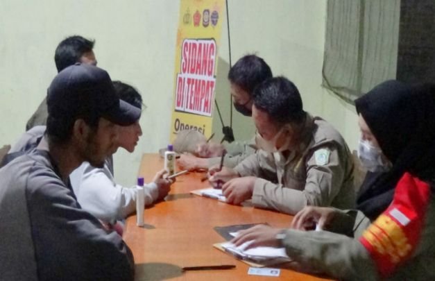 Foto: Petugas mendata / mencatat identitas dan memberikan sanksi